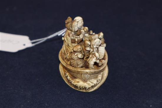 A Japanese ivory okimono netsuke of a dog with a mallet